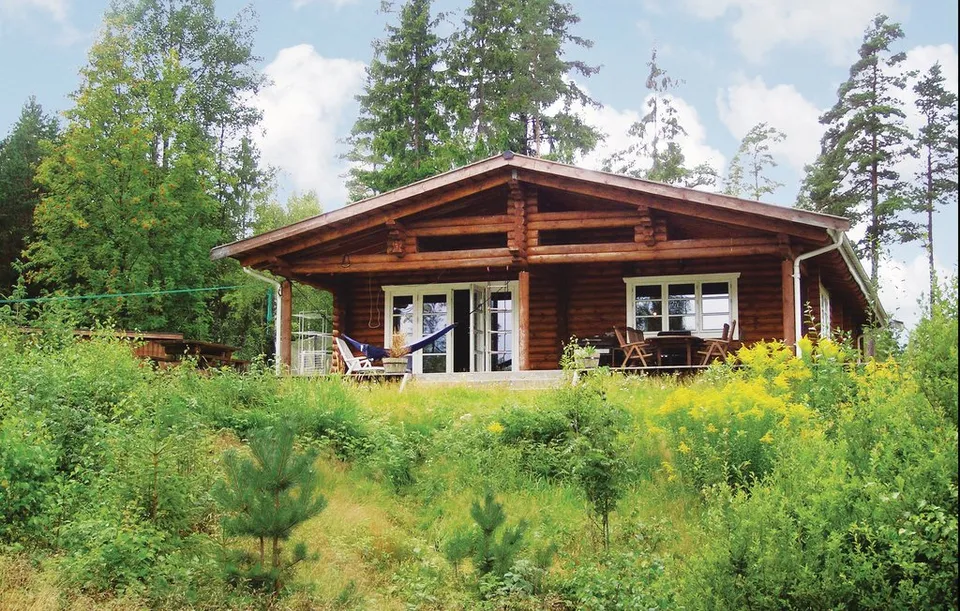 Skoustuga surrounded by green trees